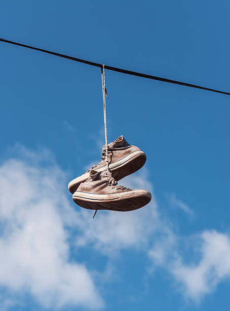 why do people hang shoes on power lines, 