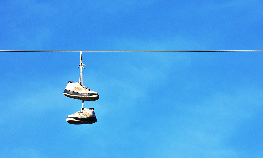 why do people hang shoes on power lines, 